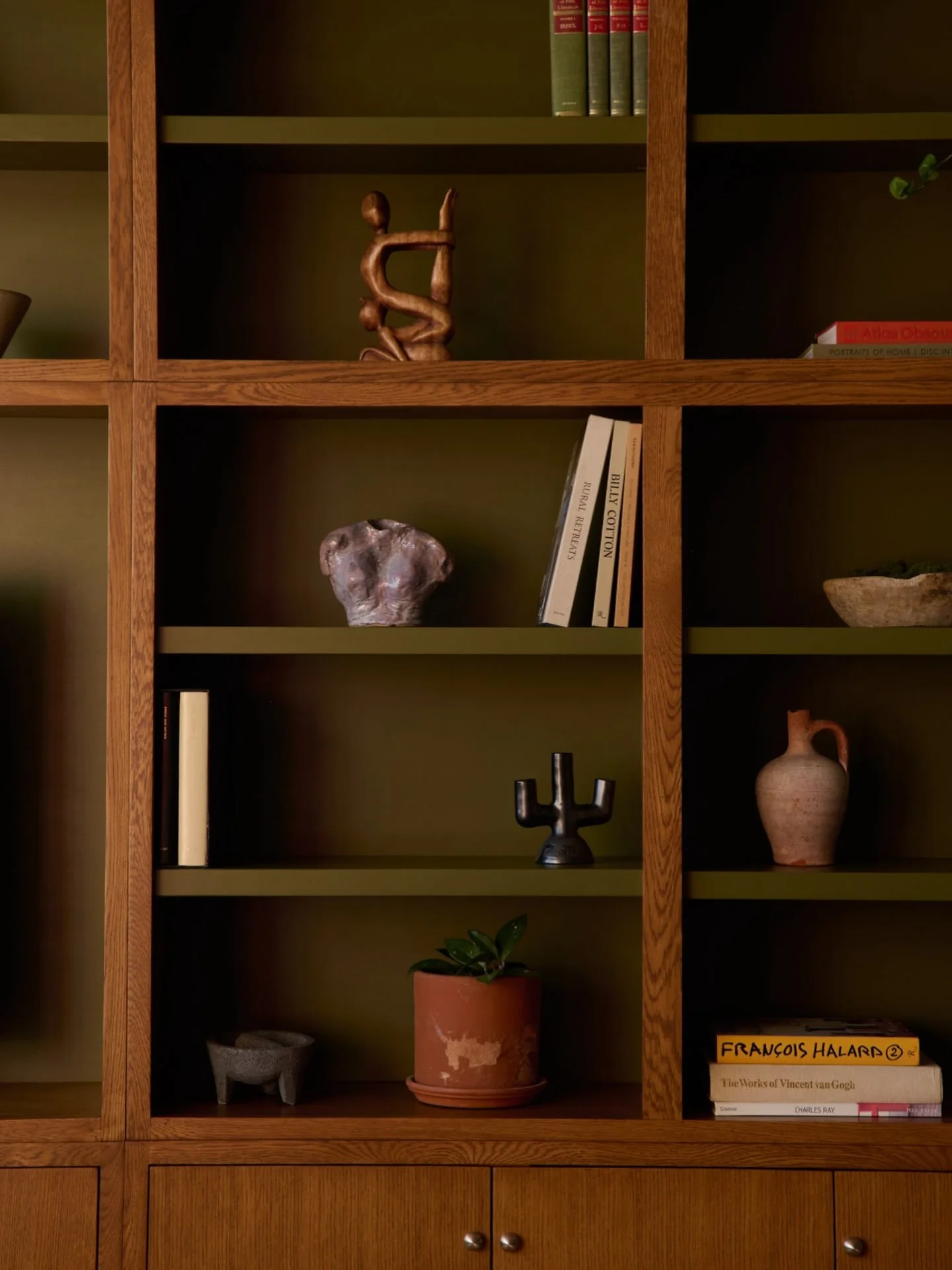 Pine green, stained oak, and a whole lot of soul. Custom floor-to-ceiling shelving at our Nabisco project