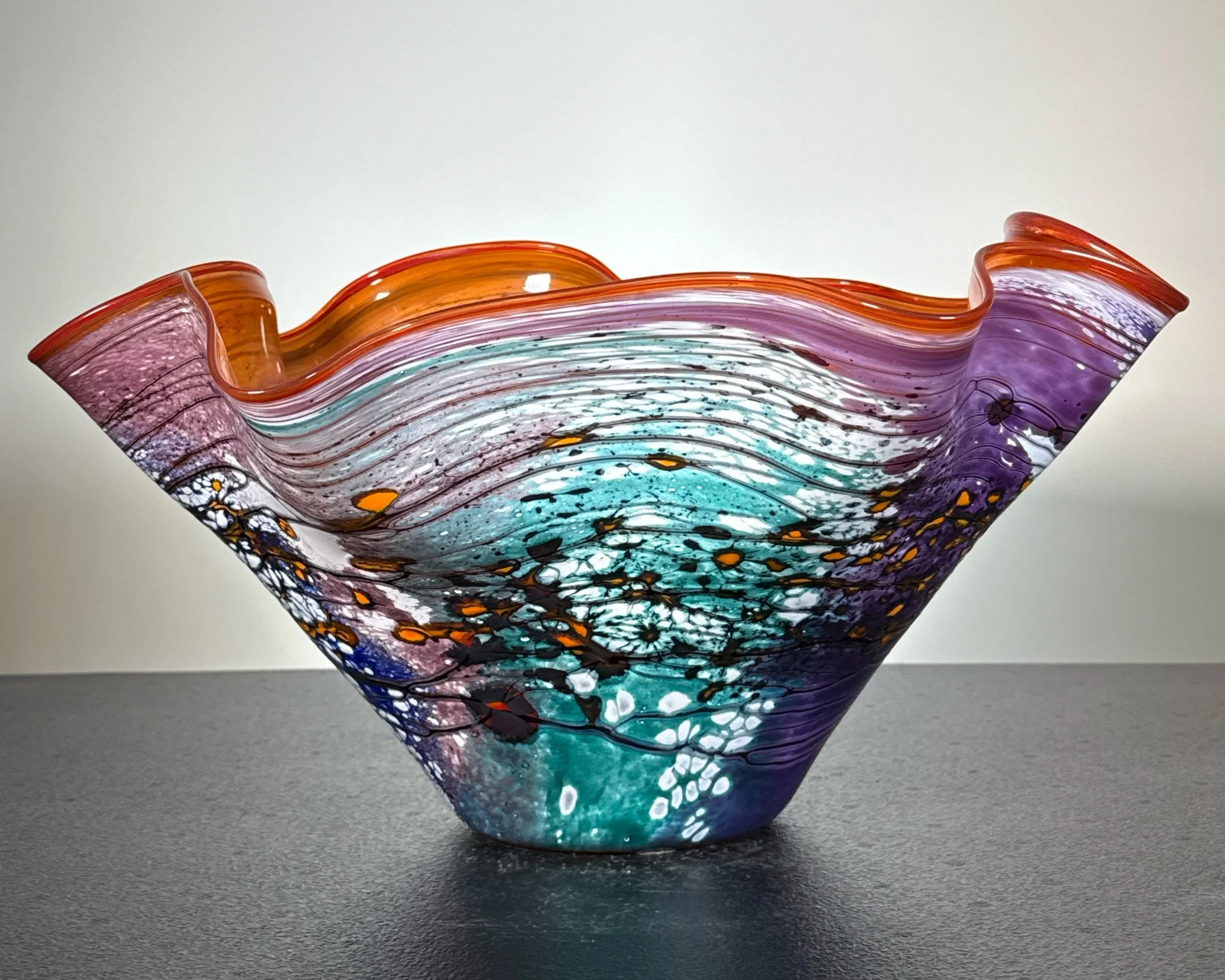 A studio art glass bowl offered by ACES Gallery