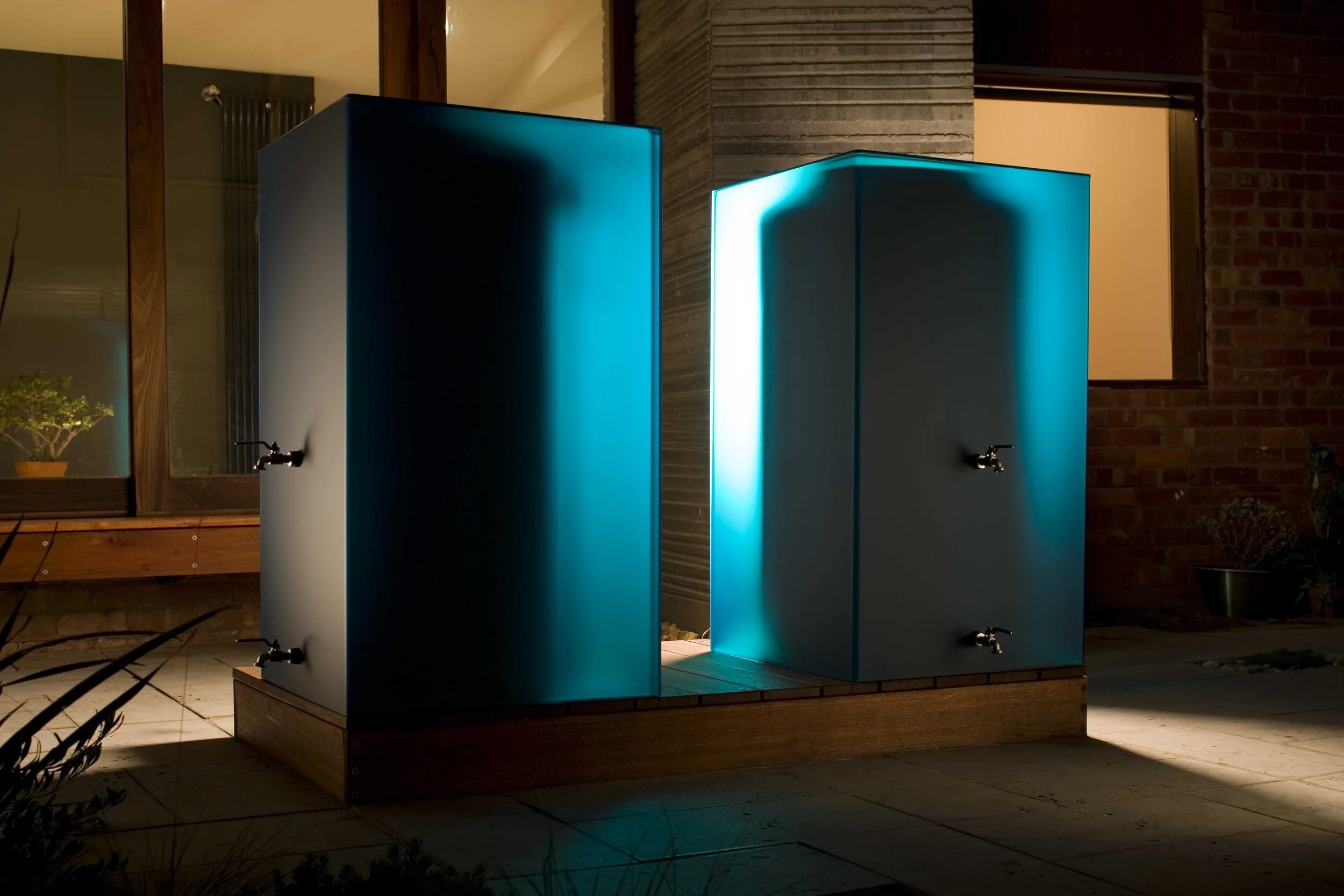 lumi-teal-rainwater-tank-kensington-night-logan-studio-©-lsa-smg.jpg