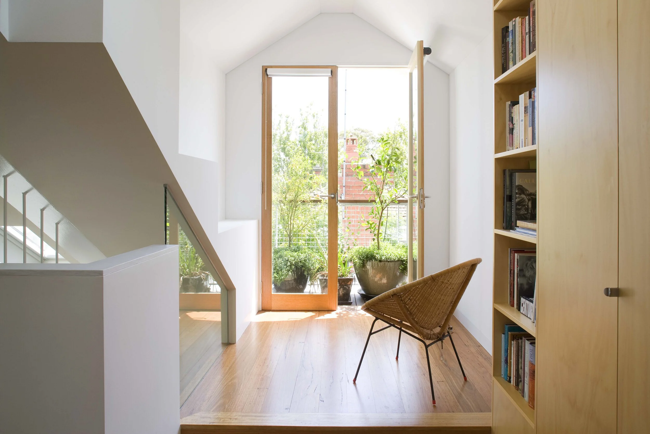 Light-filled loft studio with north-facing balcony provides independent living space without ground-floor extension disruption.