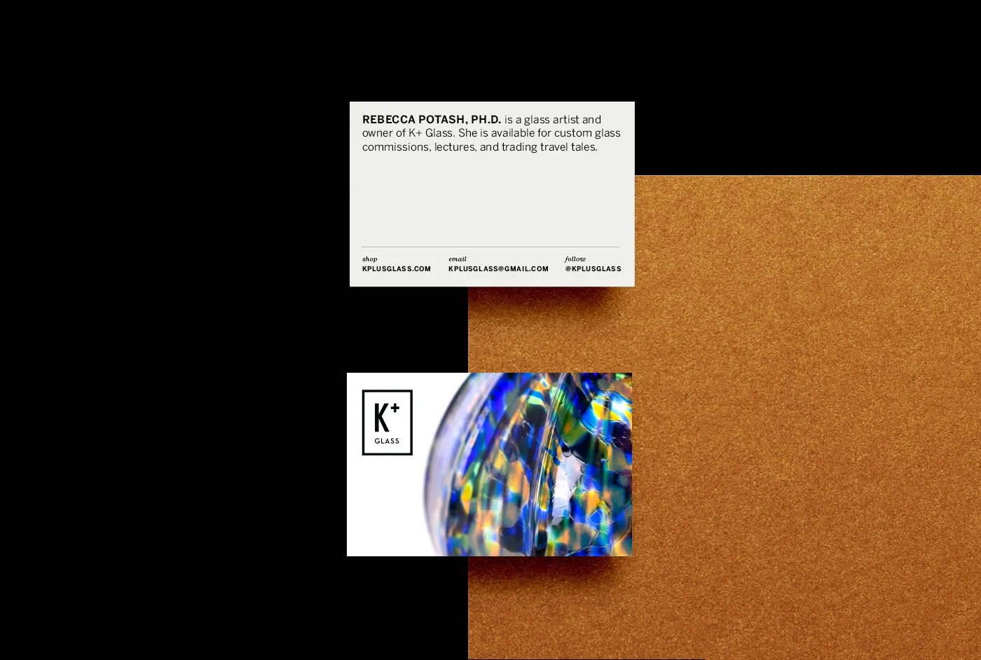 An image of business cards positioned on a cardboard and black background