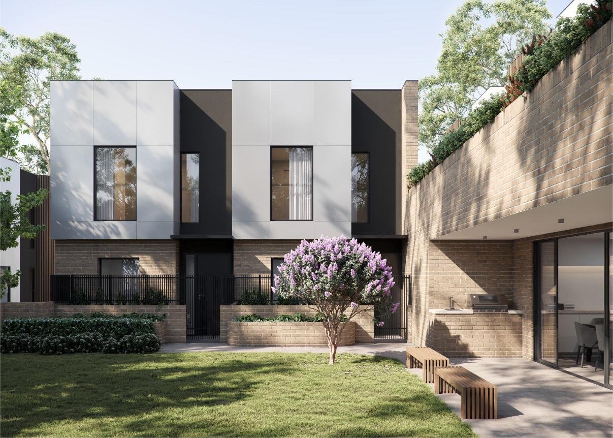 Modern multi-story residential building with a small front yard, blooming purple flowering tree, and outdoor seating area.