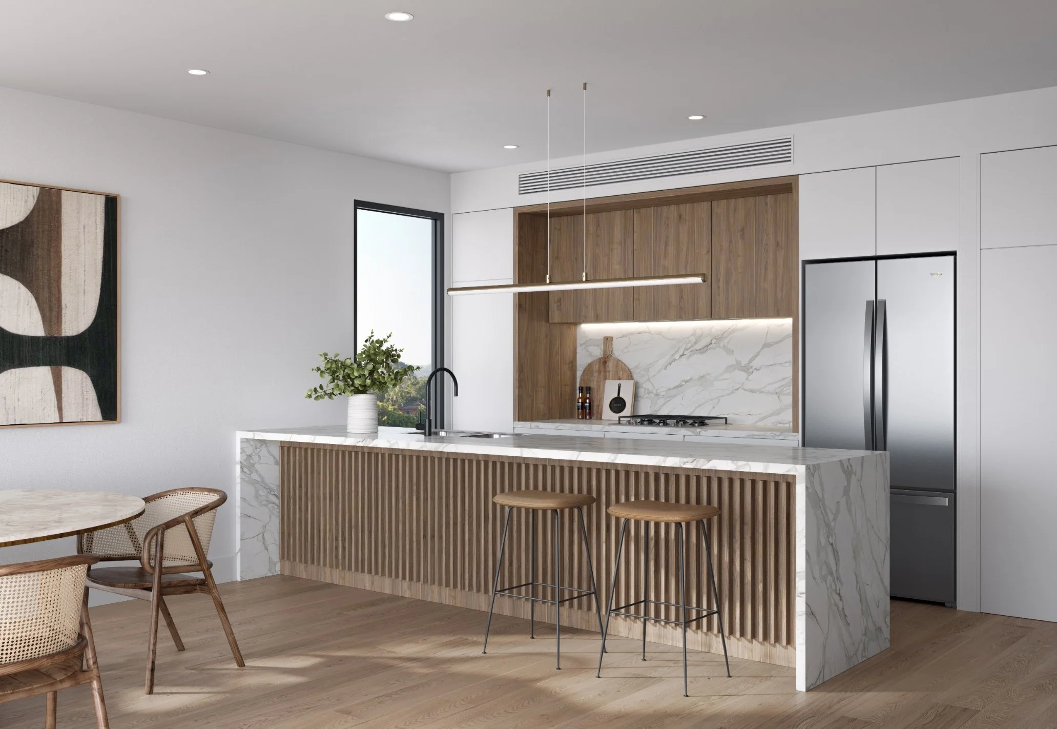 Modern kitchen with white and wooden cabinets, marble countertops, and a stainless steel refrigerator. There are bar stools at a marble island and a decorative wall art piece on the left.