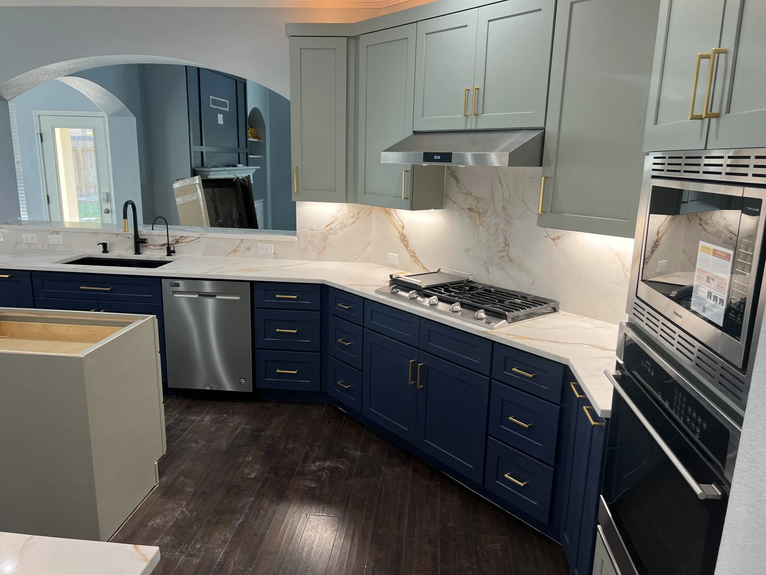 Kitchen Transformation in Round Rock, Texas with Shaker Moss & Shaker Navy paired beautifully with quartzite countertops