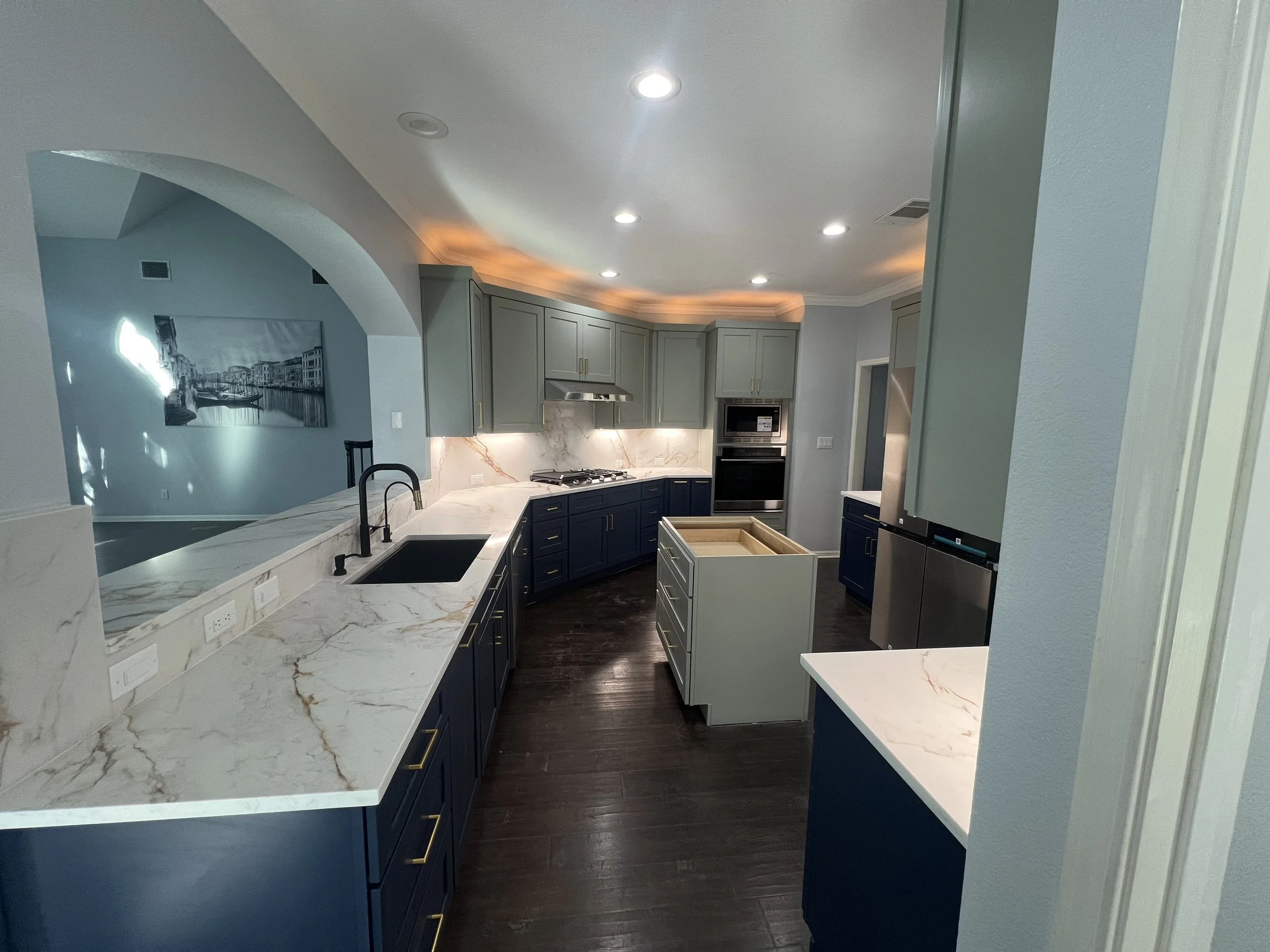 Kitchen Transformation in Round Rock, Texas with Shaker Moss & Shaker Navy paired beautifully with quartzite countertops