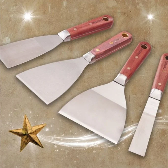 Four putty knives with wooden handles on a decorative background with stars.