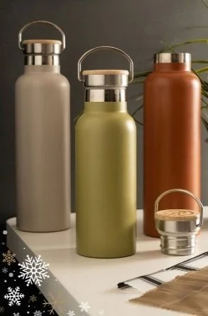 Three metal water bottles in gray, green, and brown, with stainless steel lids featuring handles, on a white surface with snowflake decorations.