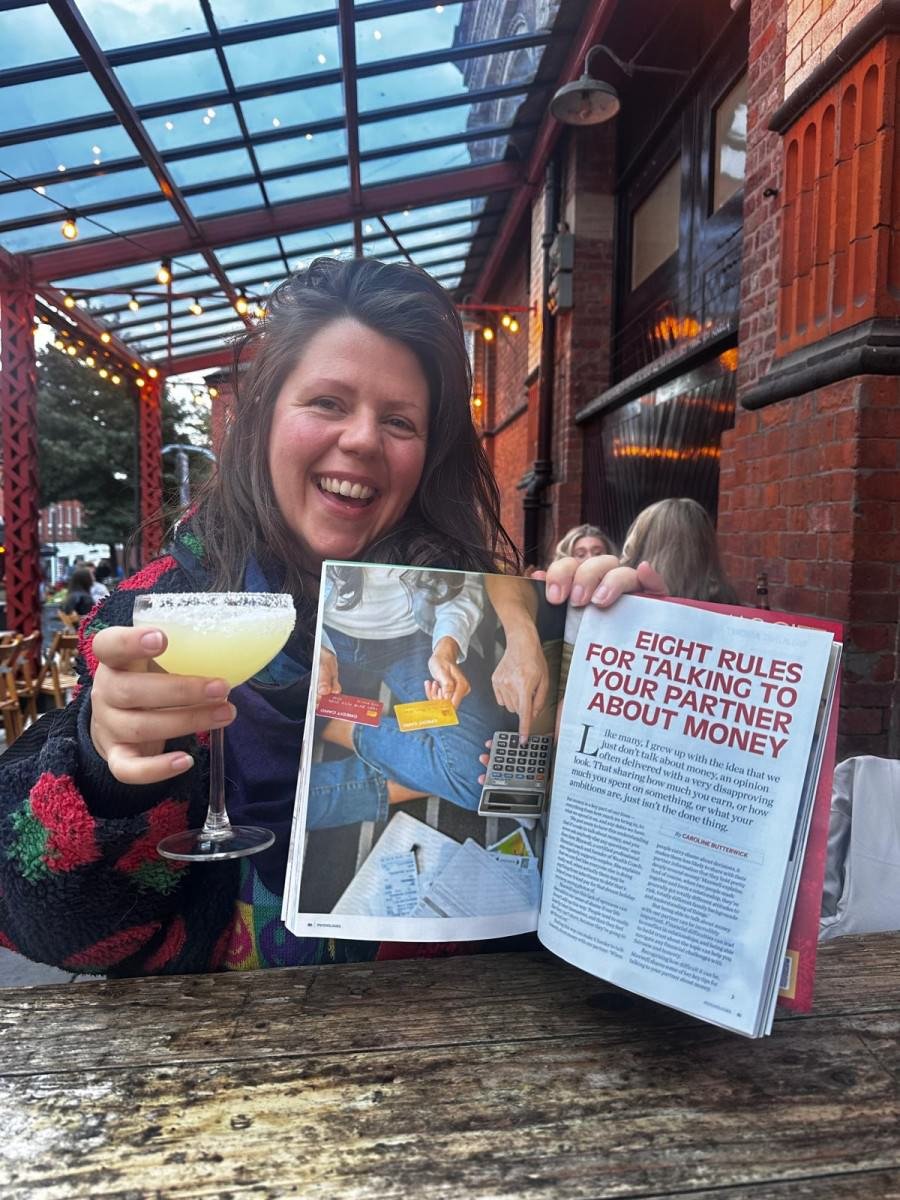 Sara Maxwell holding a copy of psychologies magazine with article featuring Wealth Coach