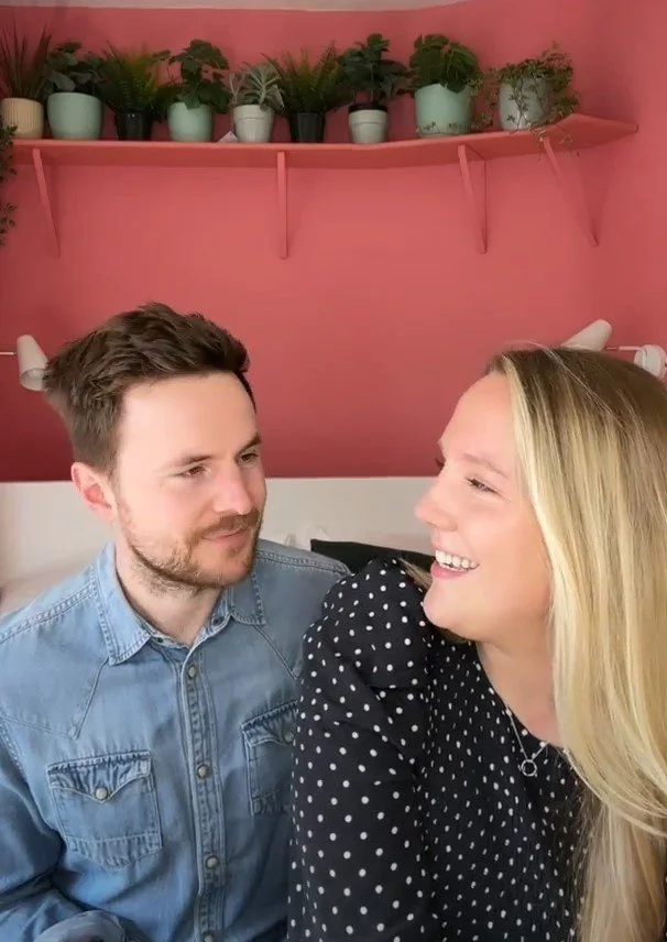 Couple looking at each other warmly while discussing their joint finances