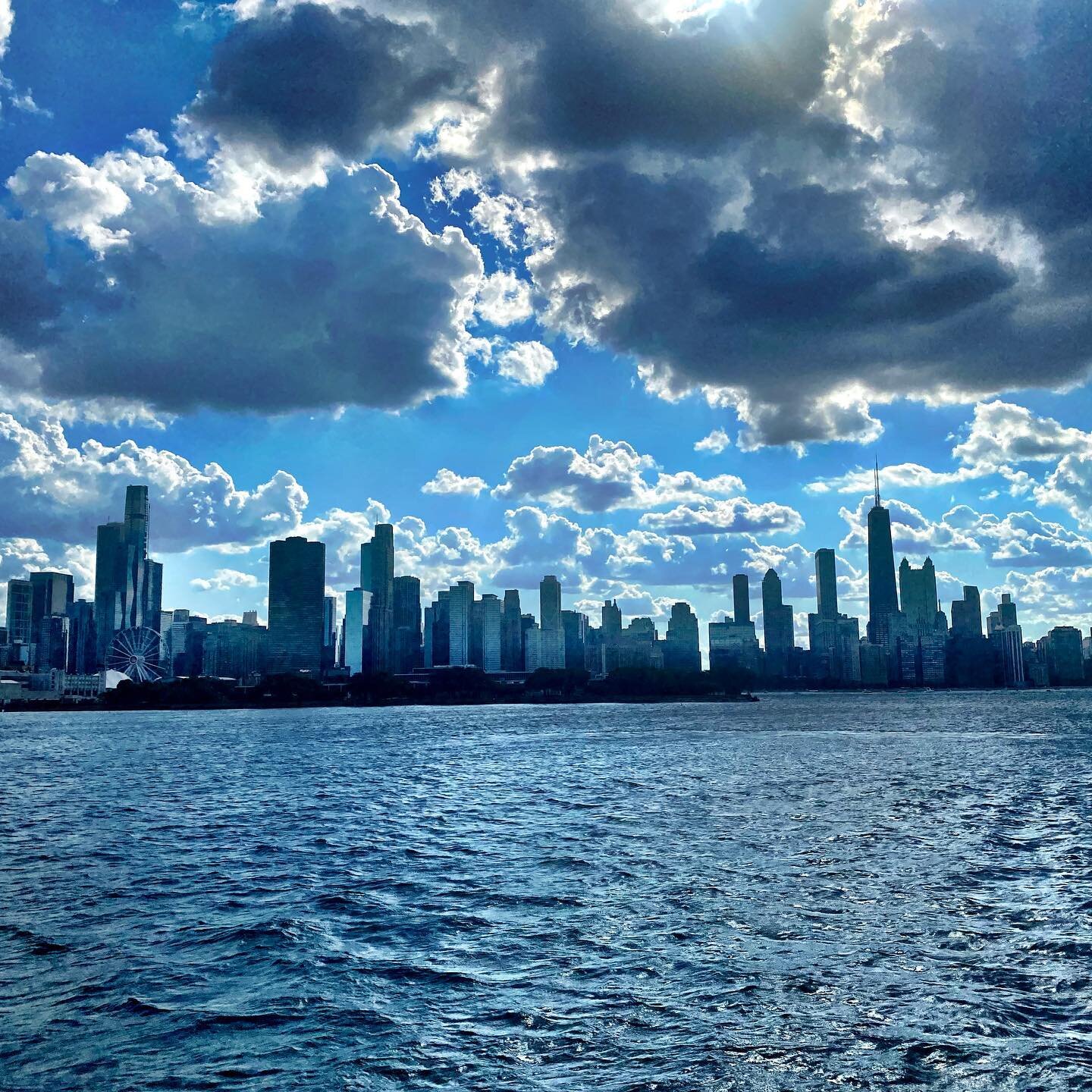 A part of the Chicago skyline seen in silhouette from a boat on Lake Michigan . 5.17 PM . July 10 2020 .