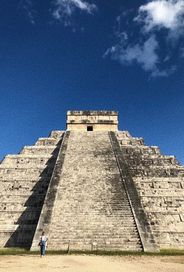 El Castillo pyramid at Chichen Itza against a blue sky.