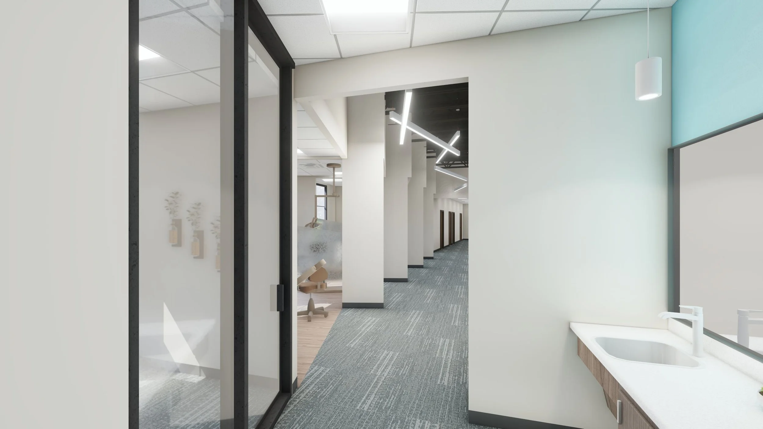 Modern office hallway with glass-walled rooms, gray carpeting, white walls, and contemporary lighting fixtures.