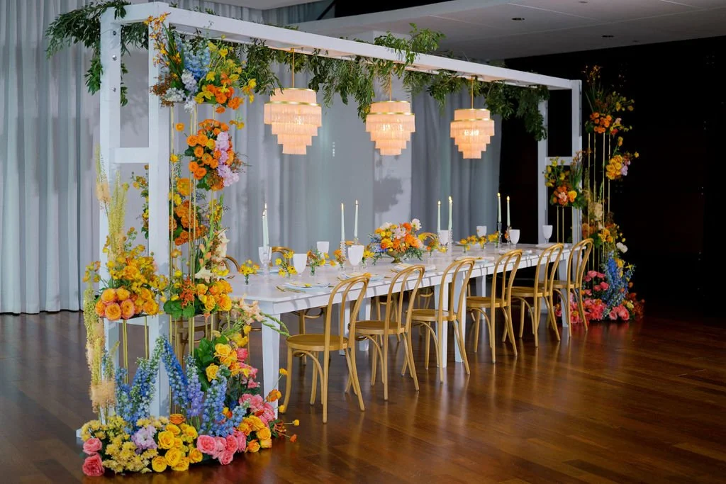White Narrow Trellis, Pink Fringe Chandeliers, White Wood Table (Photography by Gabriel Rosario Photography, Design by CocoLuna Events)