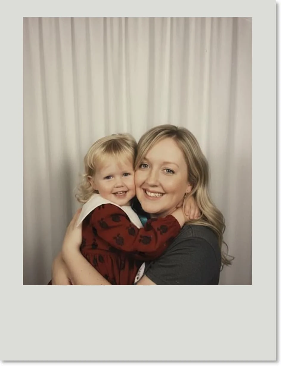 Polaroid-style image of adult Laura holding and hugging her three-year-old self, both smiling at the camera, symbolising comfort, self-compassion, and embracing her inner child.