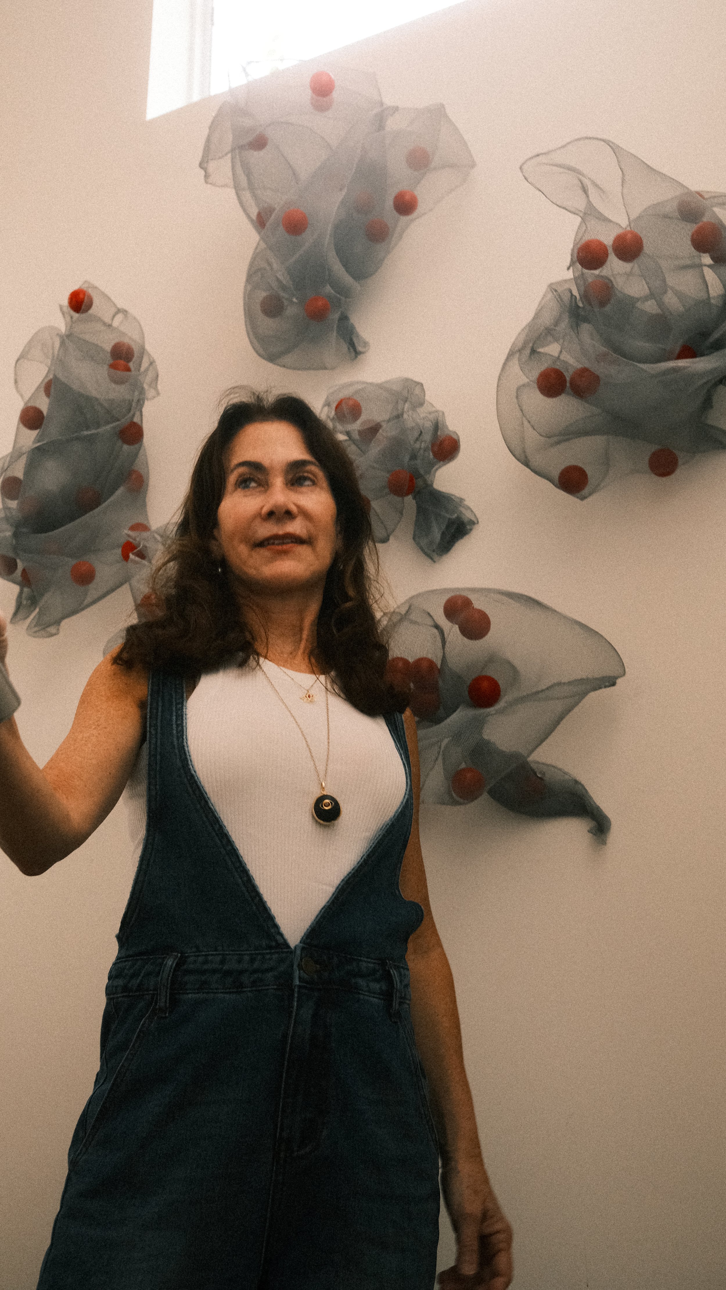 Sylvia Riquezes with suspended mobiles.