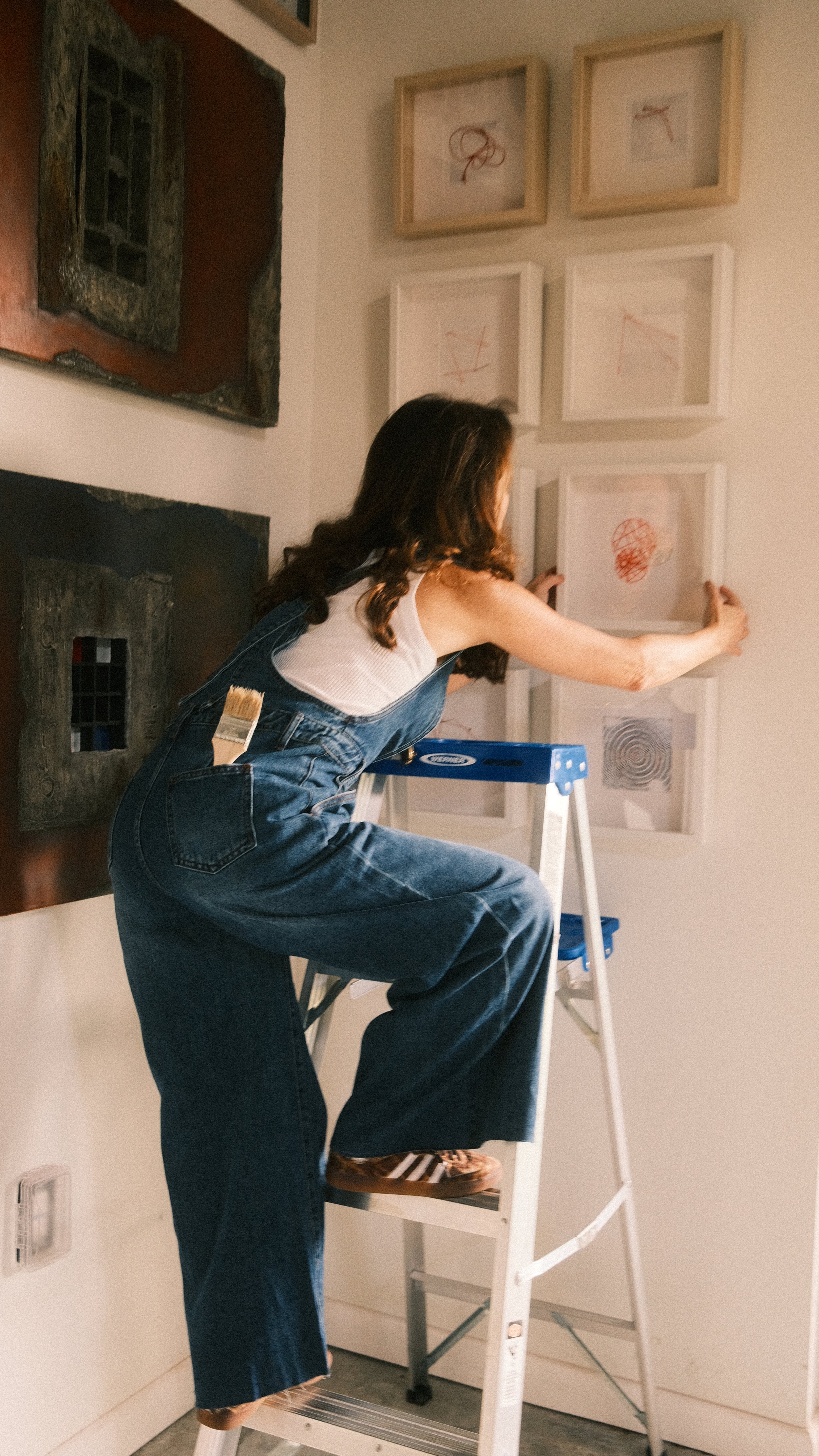 Sylvia Riquezes installing a piece in her art studio.