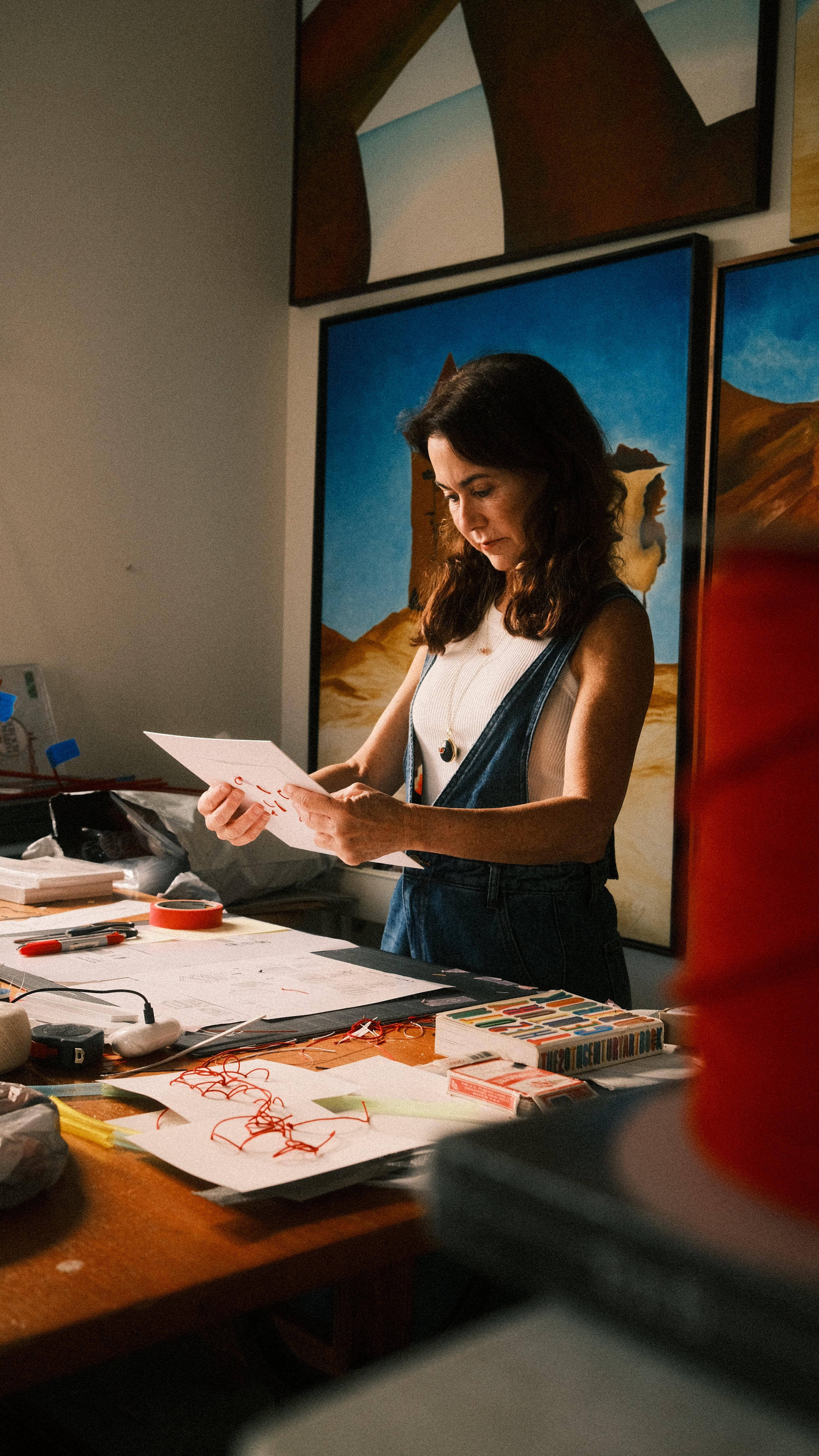 Sylvia Riquezes working on a new piece in her art studio.