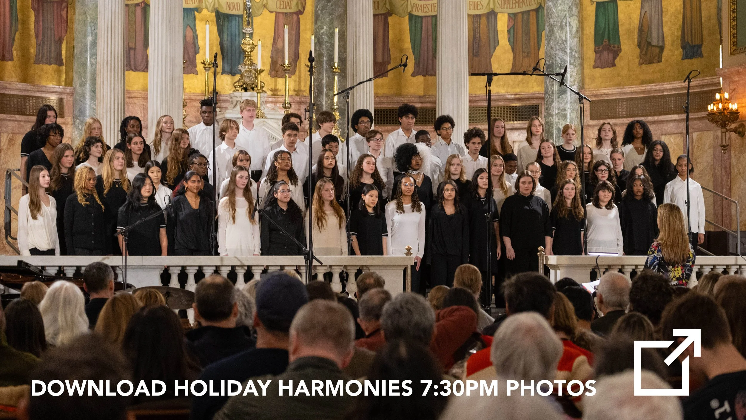 A large choir of young men and women singing on a stage in a church with ornate gold and marble decor, with an audience watching.