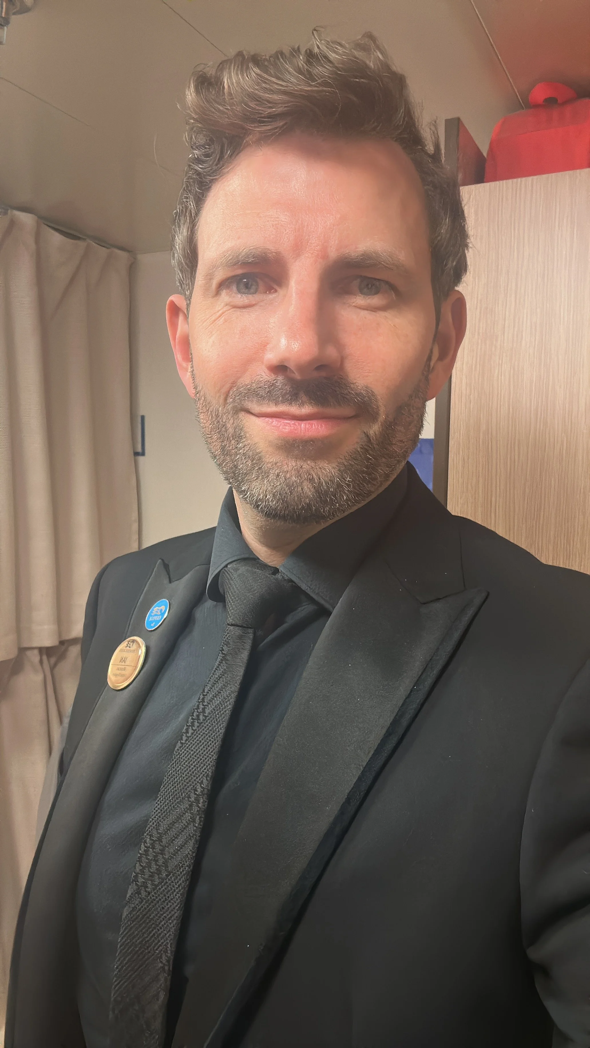 Ian onboard Princess Cruises wearing a suit and tie