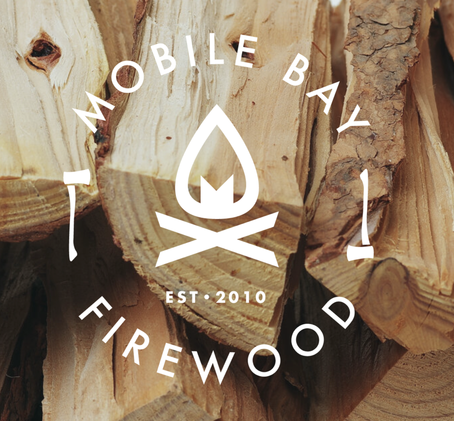 Stack of firewood with "Mobile Bay Firewood" logo, including a stylized campfire and axes, established in 2010.