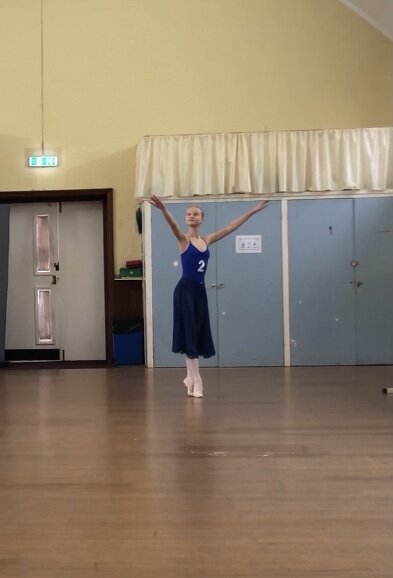 Alta Academy of Dance Brighton, Ballet dancer on demi-pointe with arms in open 5th