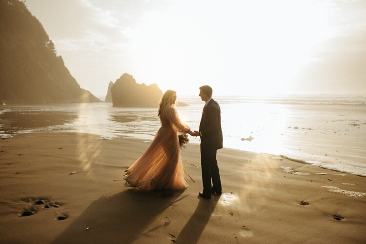Bride-and-groom-spinning-on-beach-at-sunset.jpg