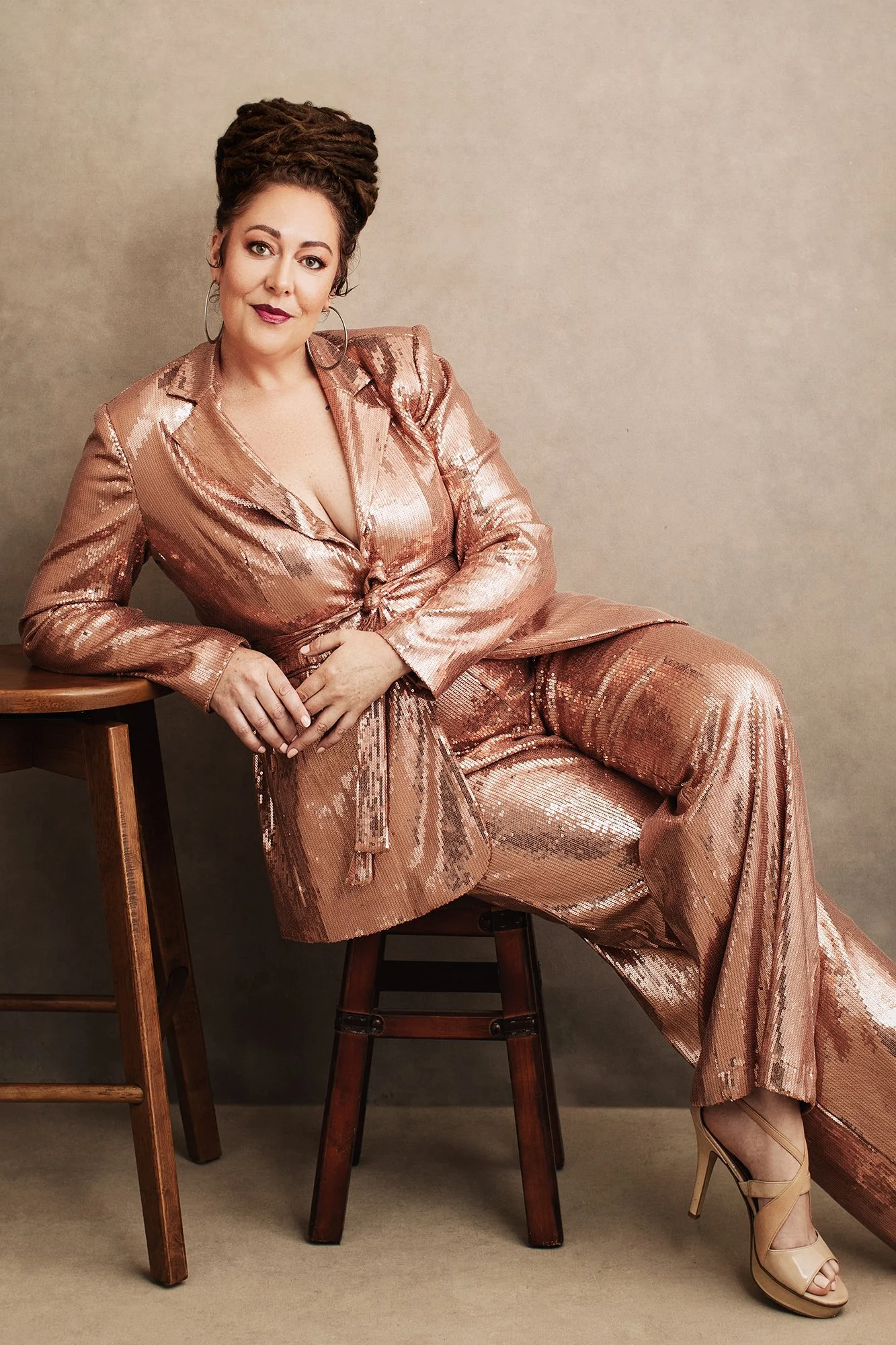Elegant woman wearing a sequin dress dress photographed during a luxury editorial portrait session in Austria.
