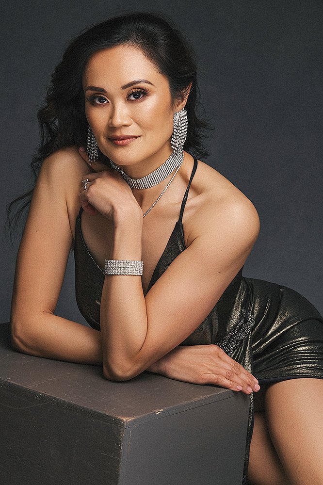 Elegant woman over 40 in an gold evening gown photographed in a luxury magazine-style portrait session in Tirol.