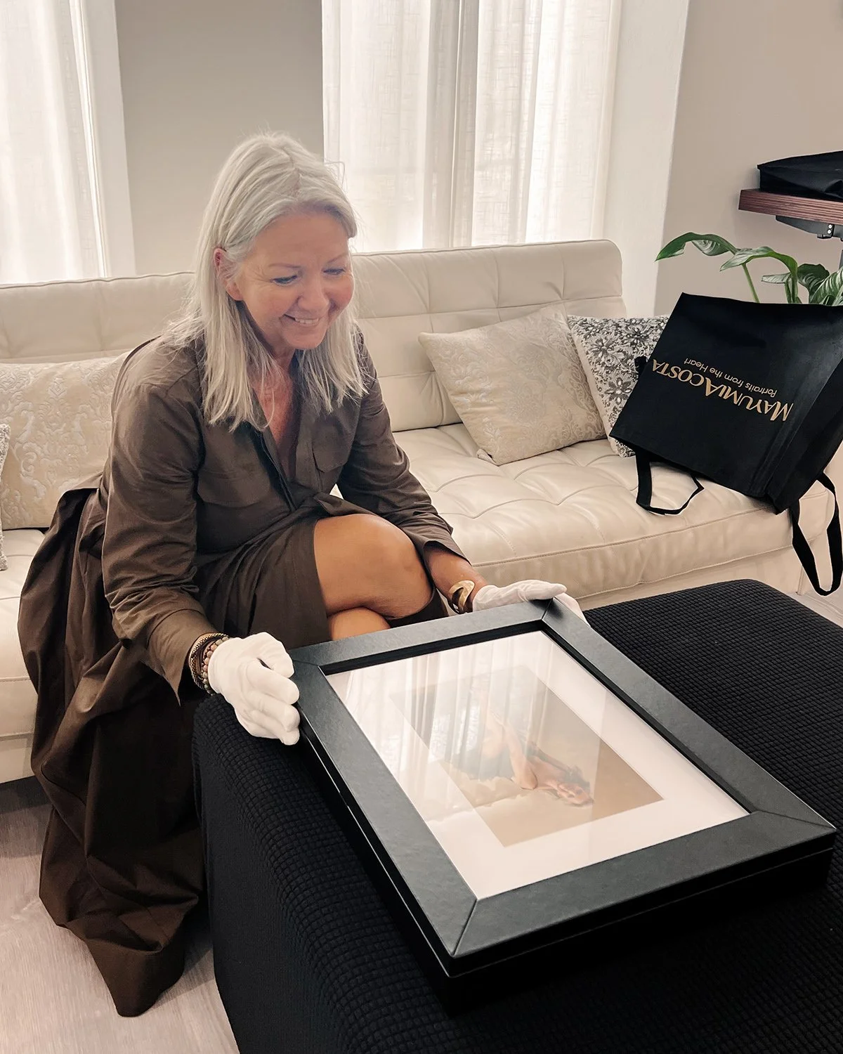 Client-holding-a-Folio-Collection-from-a-portrait -session-with-Mayumi-Acosta-Photography.jpg