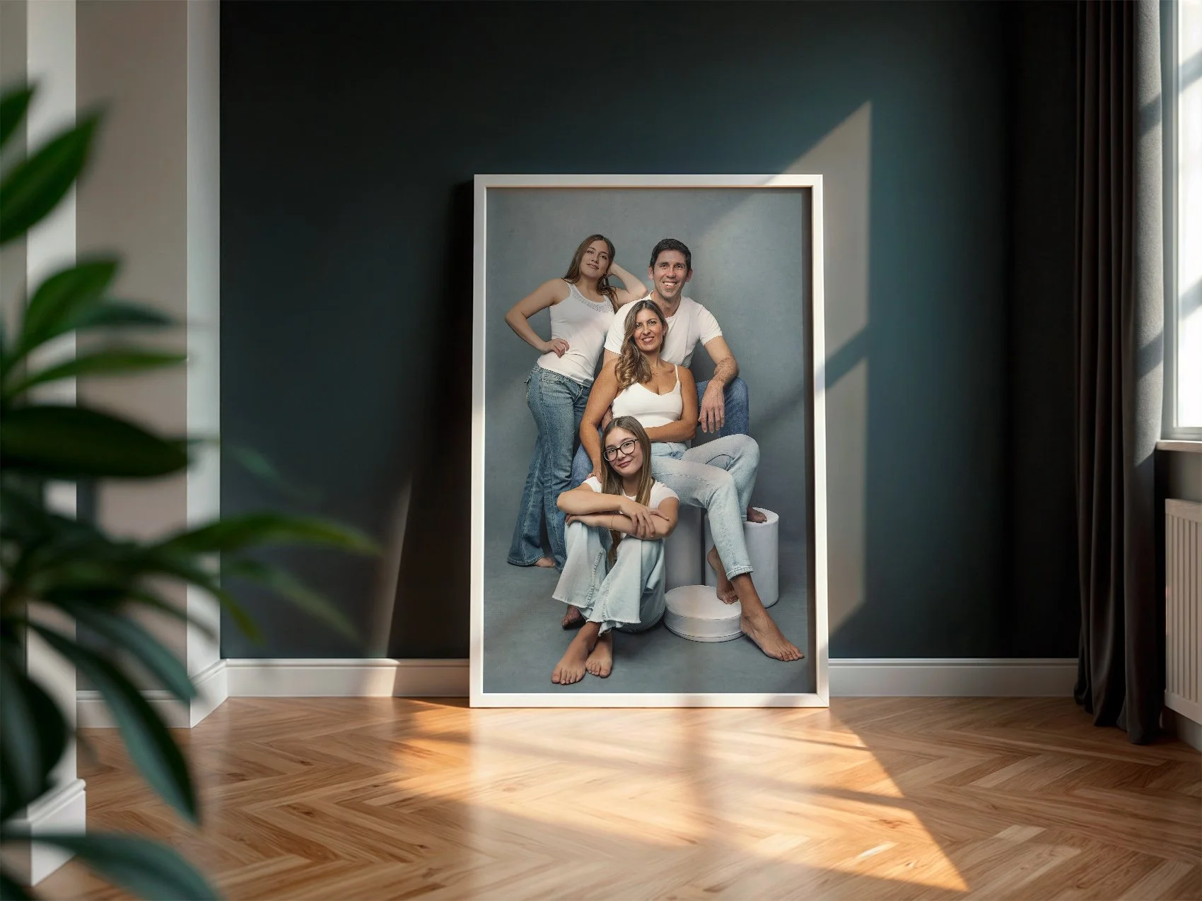 A large framed family portrait leaning against a dark wall in a modern home interior, photographed by Mayumi Acosta Photography in Innsbruck