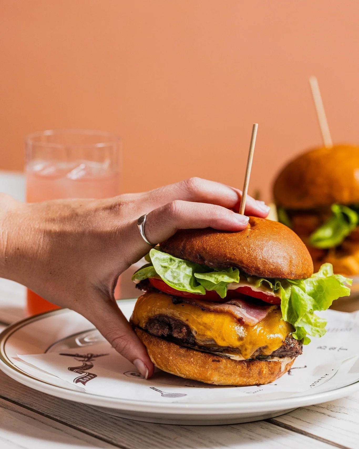 You'll need two hands for this one...
Our Wagyu Cheeseburger with onion, pickles, burger sauce, fries + Smoked streaky bacon.