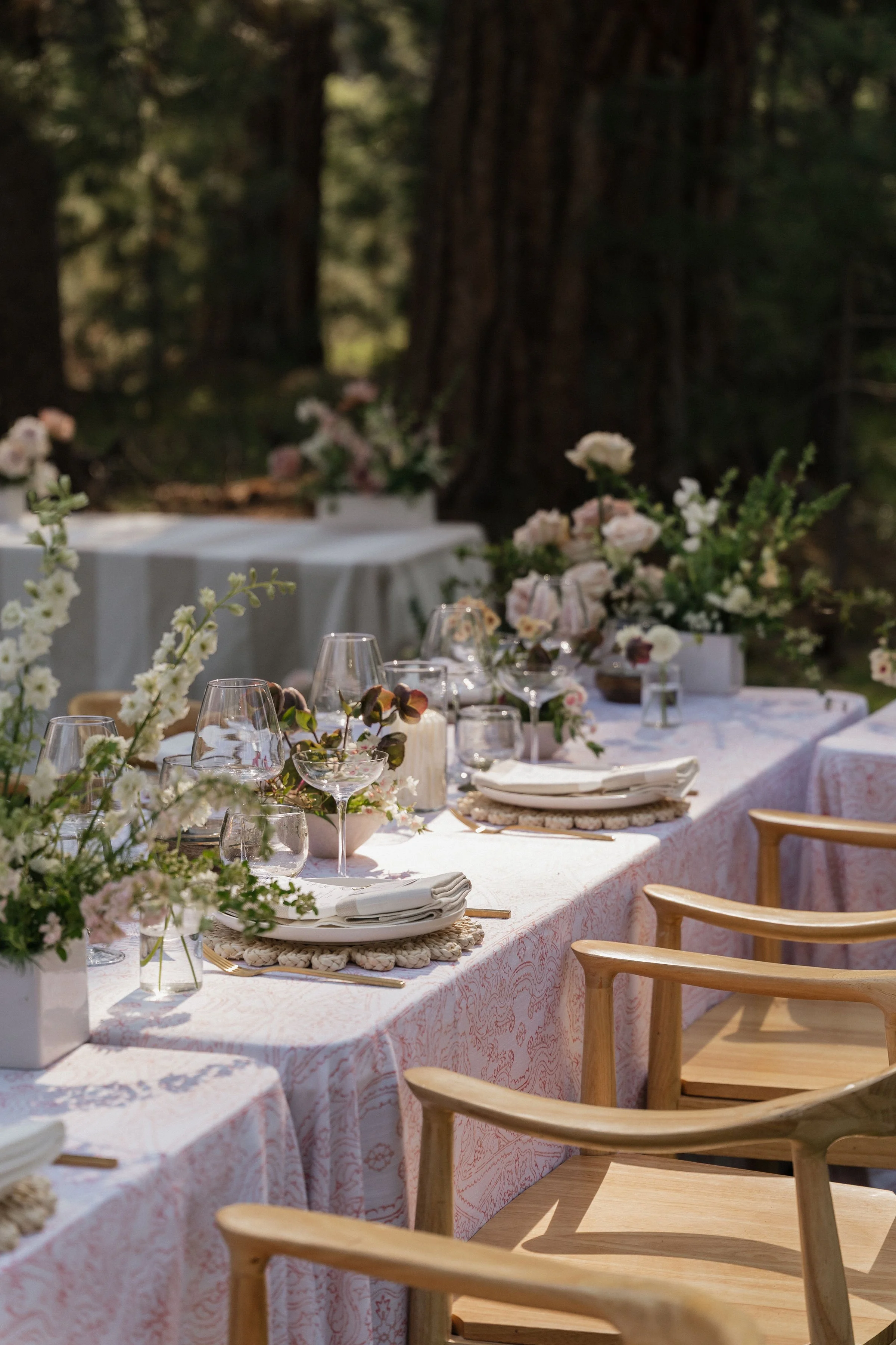 Paisley print pink linens with blush pink florals and luxury tabletop decor for outdoor wedding
