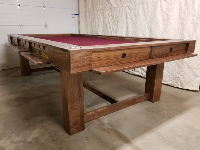 Custom handcrafted walnut board game table with a red felt vault and wood topper. Durable construction and versatile design for extended play sessions.