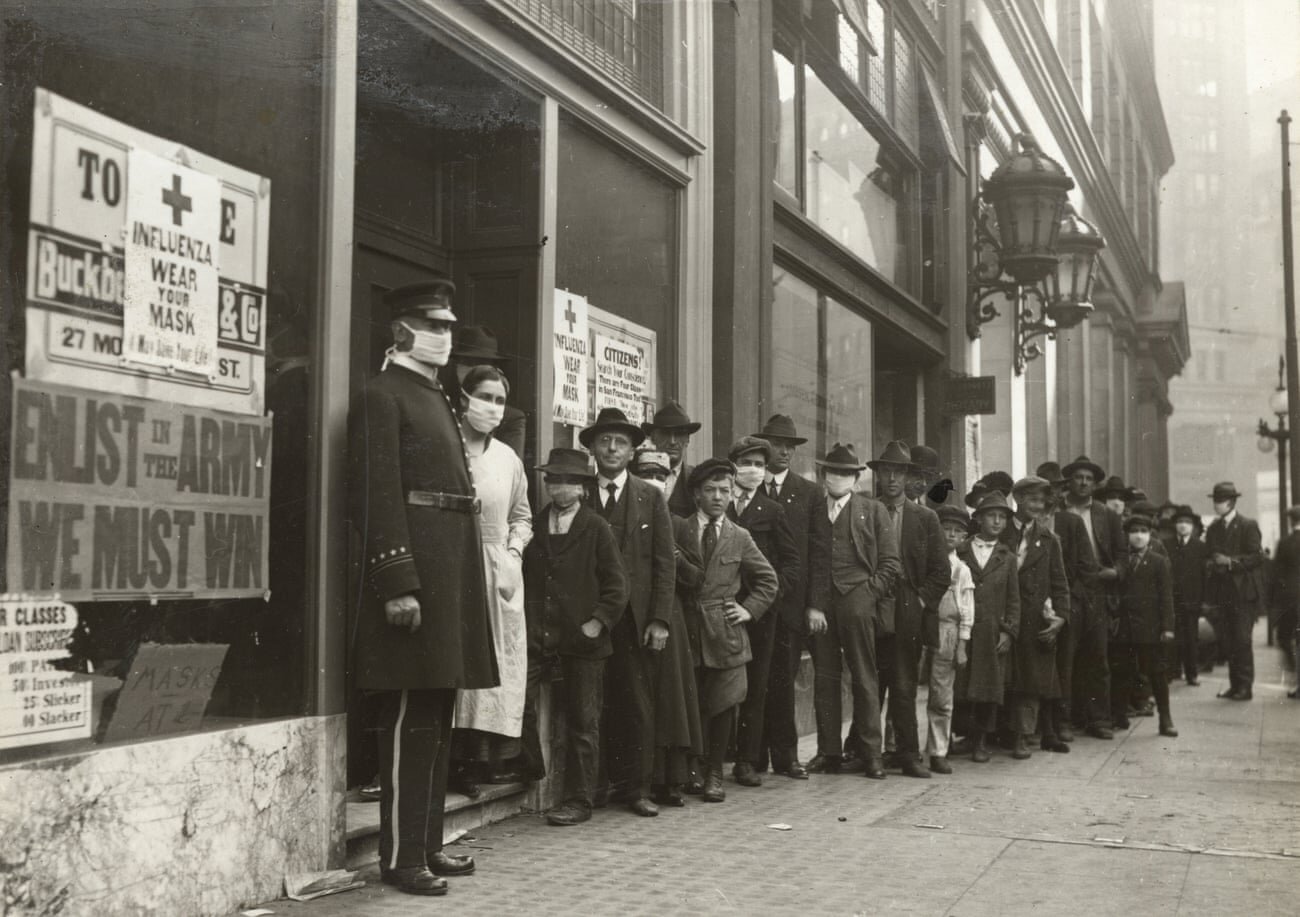 The start of the 1920s was bleak. Here, people wait in line to get flu masks to avoid the spread of Spanish flu on in San Francisco in 1918.