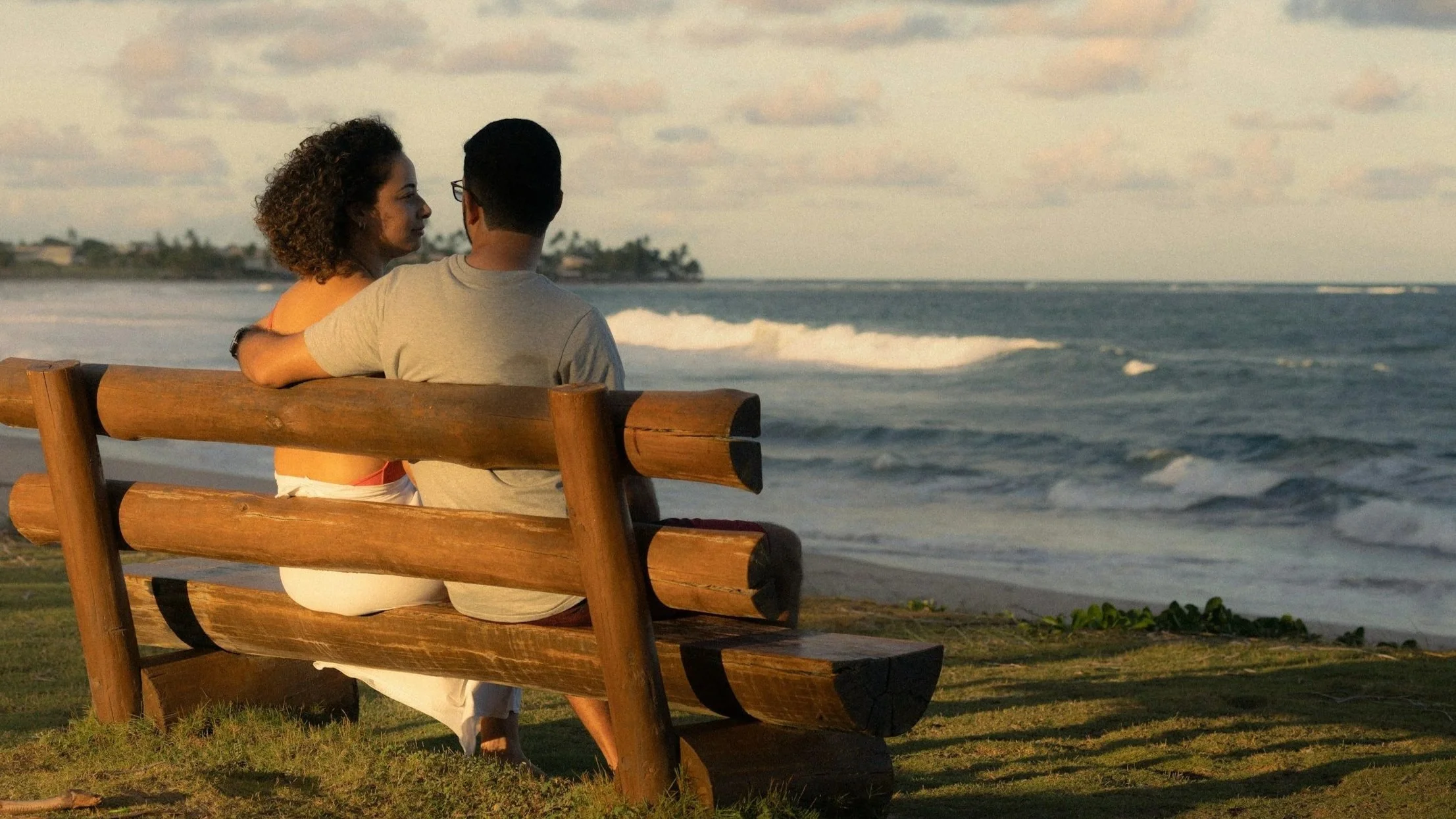 couple on bench near ocean