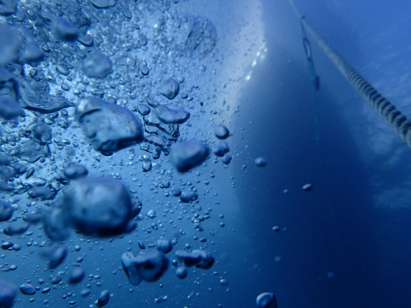 “Underwater view of air bubbles and a boat on the surface at Panama City Beach” by Sam Soffes on Unsplash