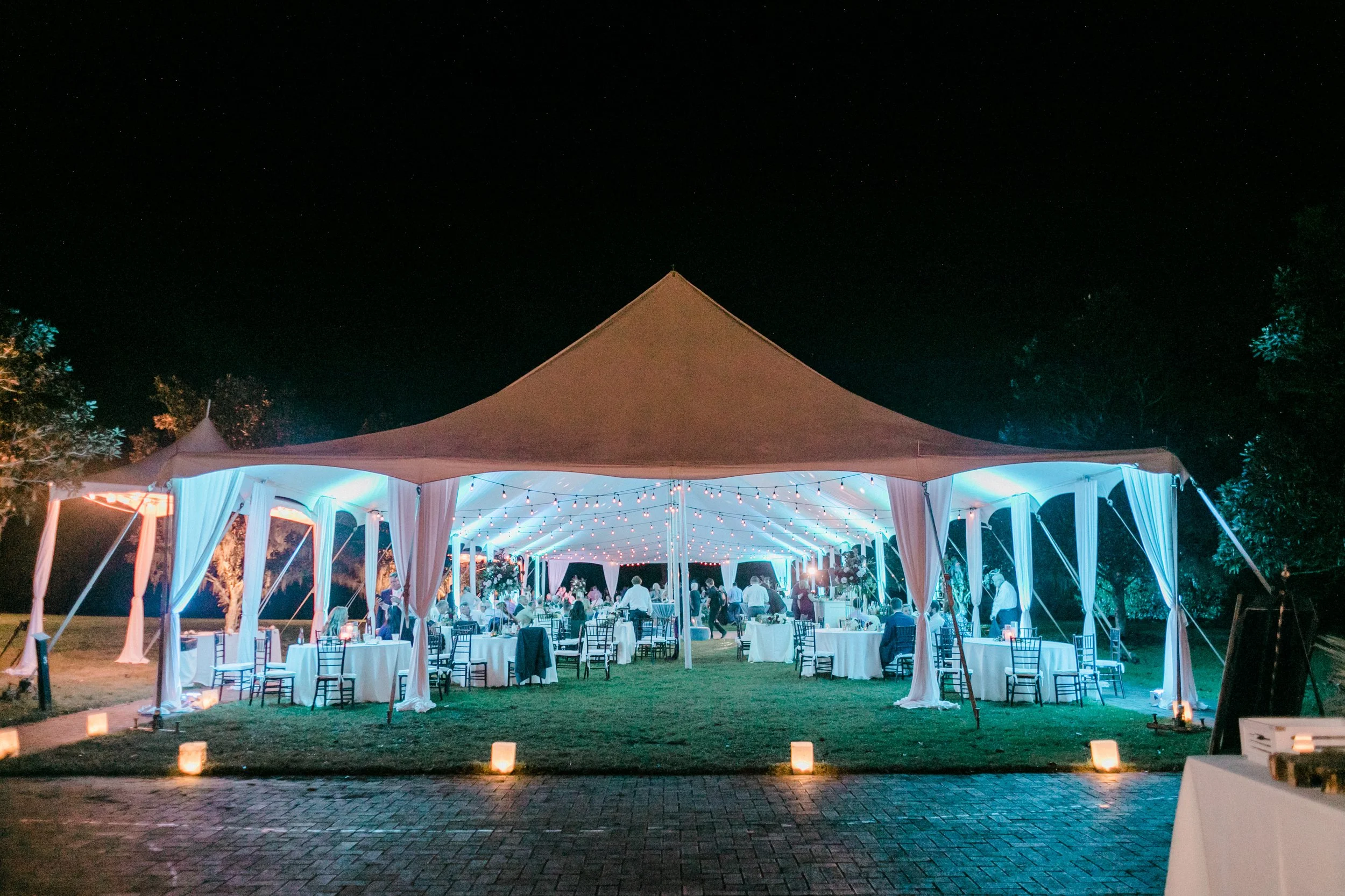 Wedding tent reception with string lights and uplighting by South Carolina DJ Joyful Entertainment