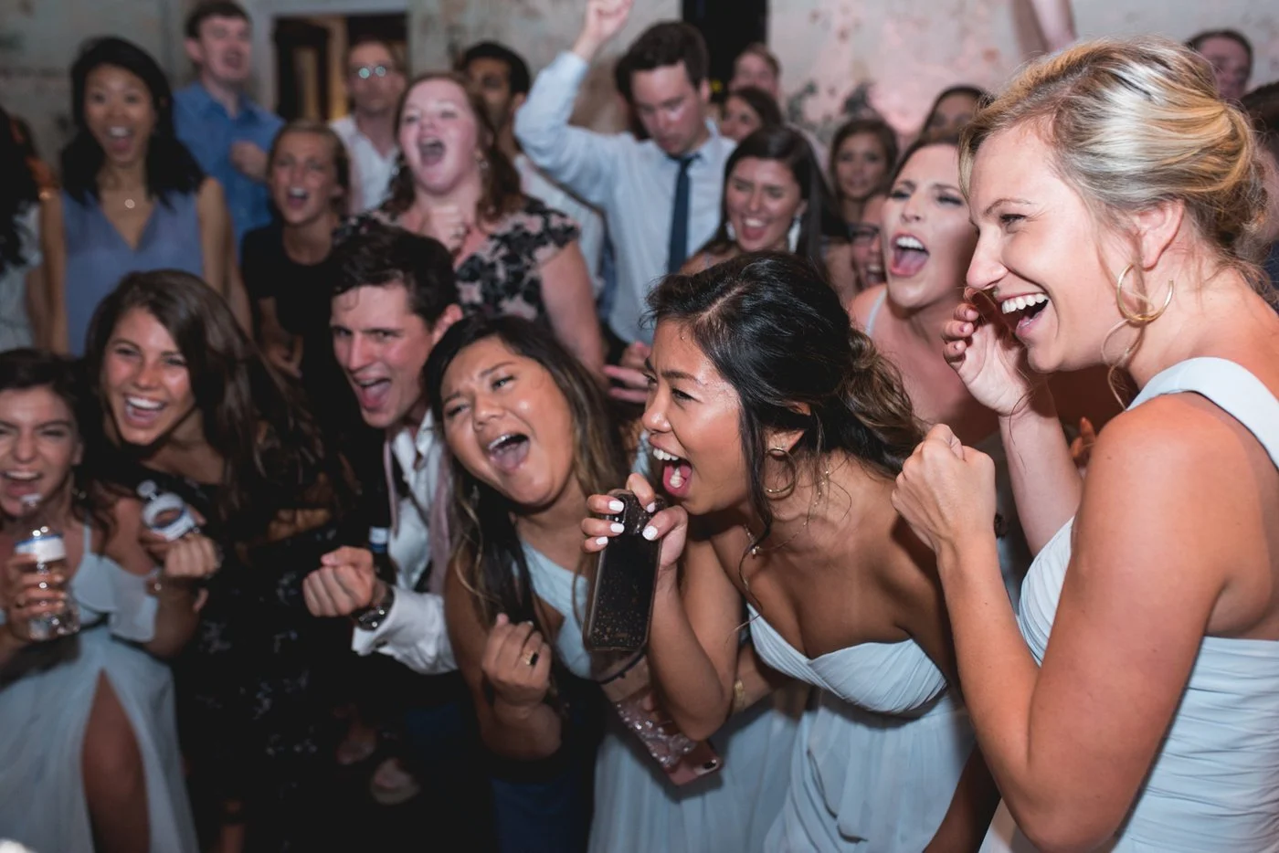 Wedding guests singing and dancing on a packed dance floor with DJ entertainment by Joyful Entertainment in South Carolina