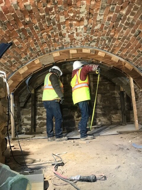 Workers under vault