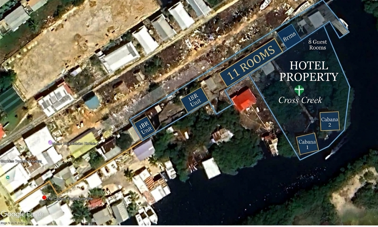 Aerial view of a hotel property called Cross Creek with 11 rooms, including guest rooms and cabins, alongside a waterway.