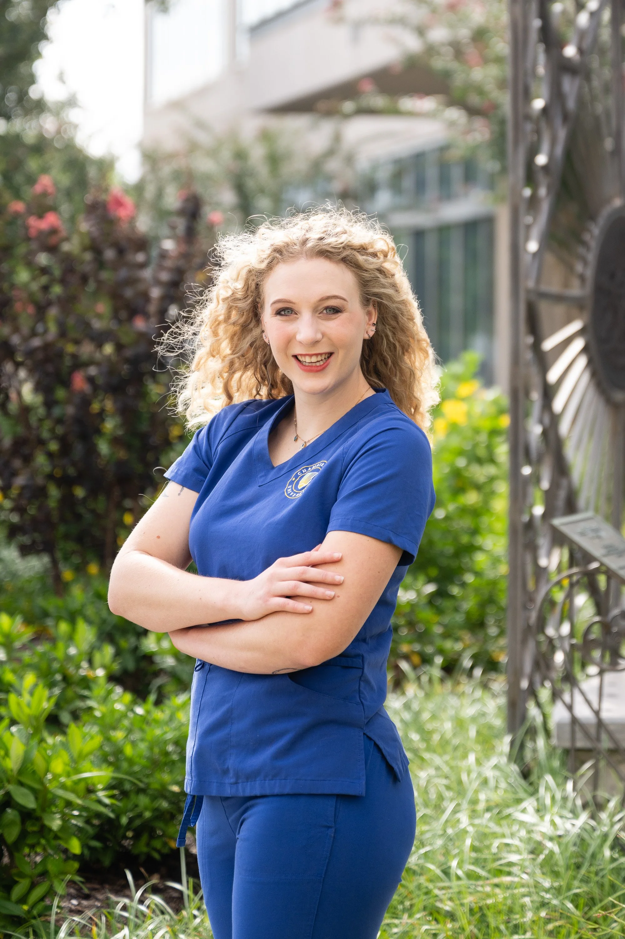 On-location outside headshot of nurse graduate standing in front of hospital she will begin working at.