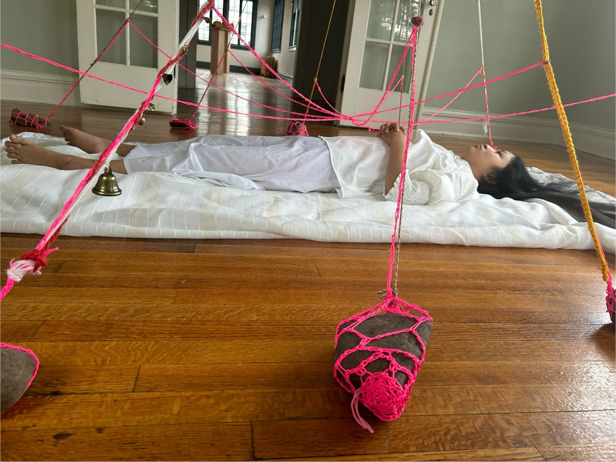 "Out of Body" performed by Faye Ross, 2024, bells, crystals, found objects, porcelain, construction string, cotton string, rocks, fabric at Tanja Grunert Gallery