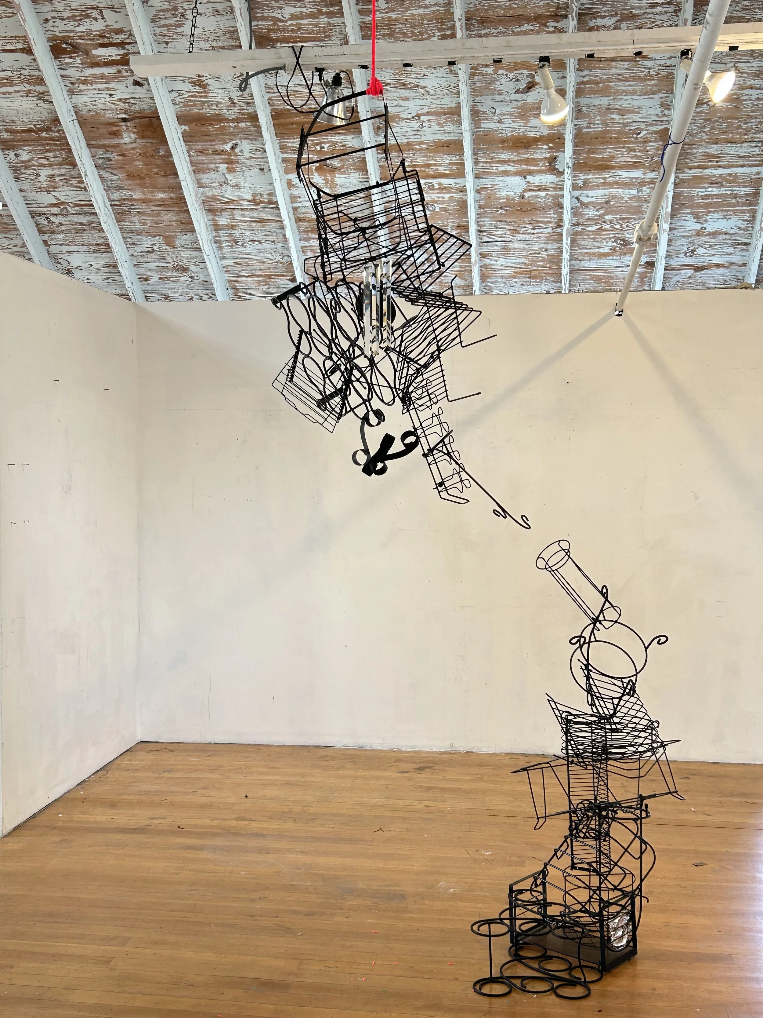 "Attraction", 2025, 36" x 14" x 144", found objects, zip ties, construction string, crystals

