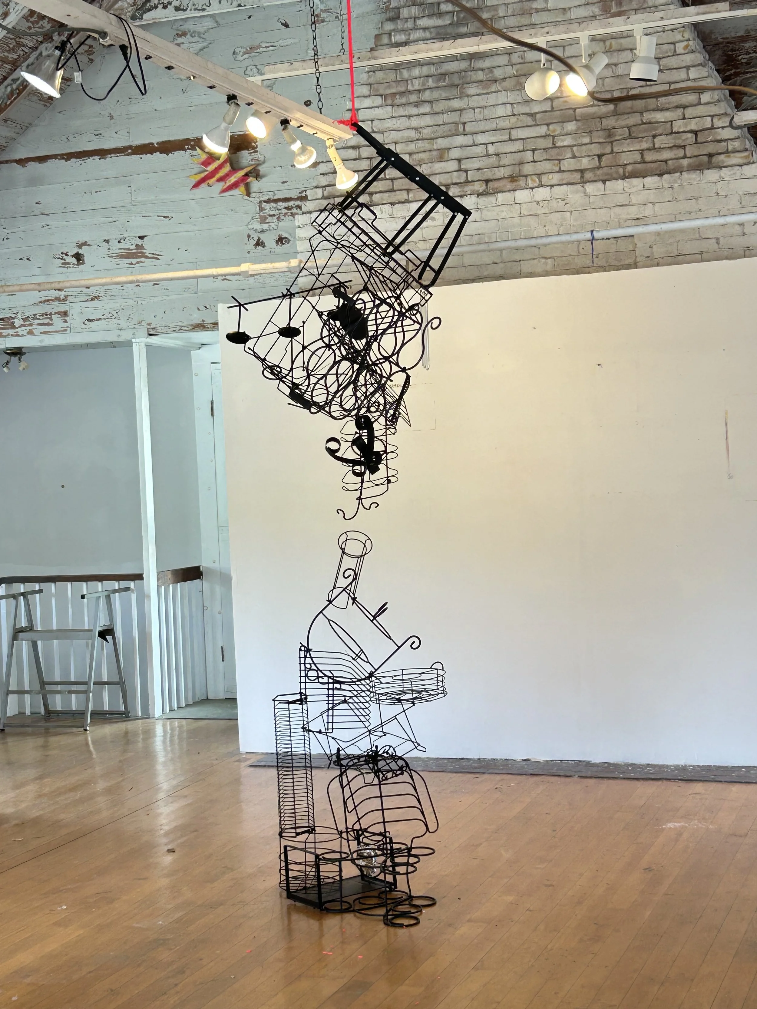 "Attraction", 2025, 36" x 14" x 144", found objects, zip ties, construction string, crystals
