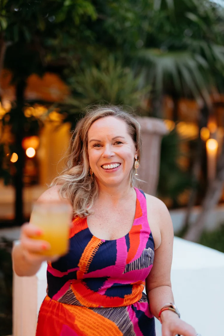 Kristin Lawton, Chief Brand Mixologist, raising a cocktail