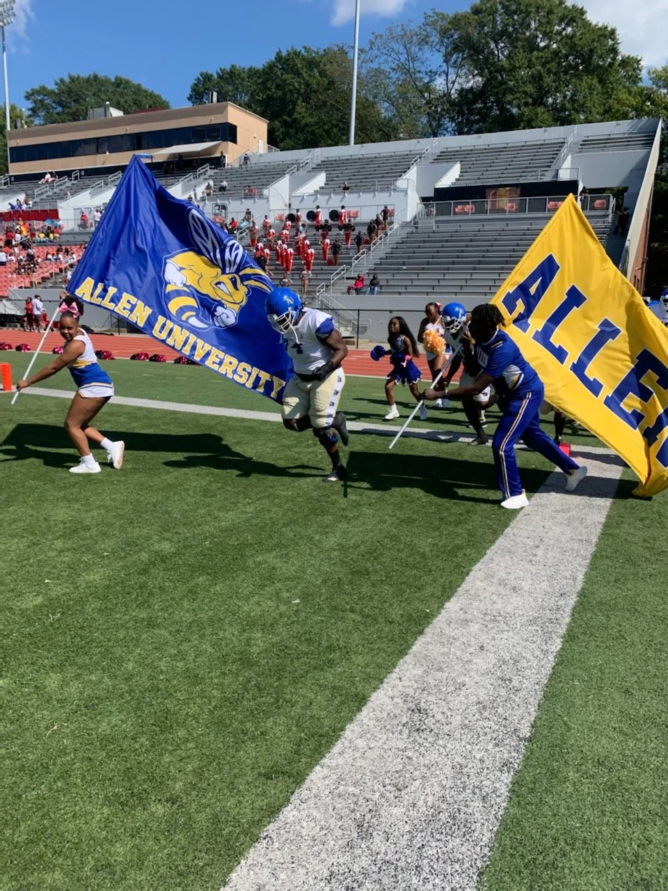 Yellow Jackets taking the field with Allen flags