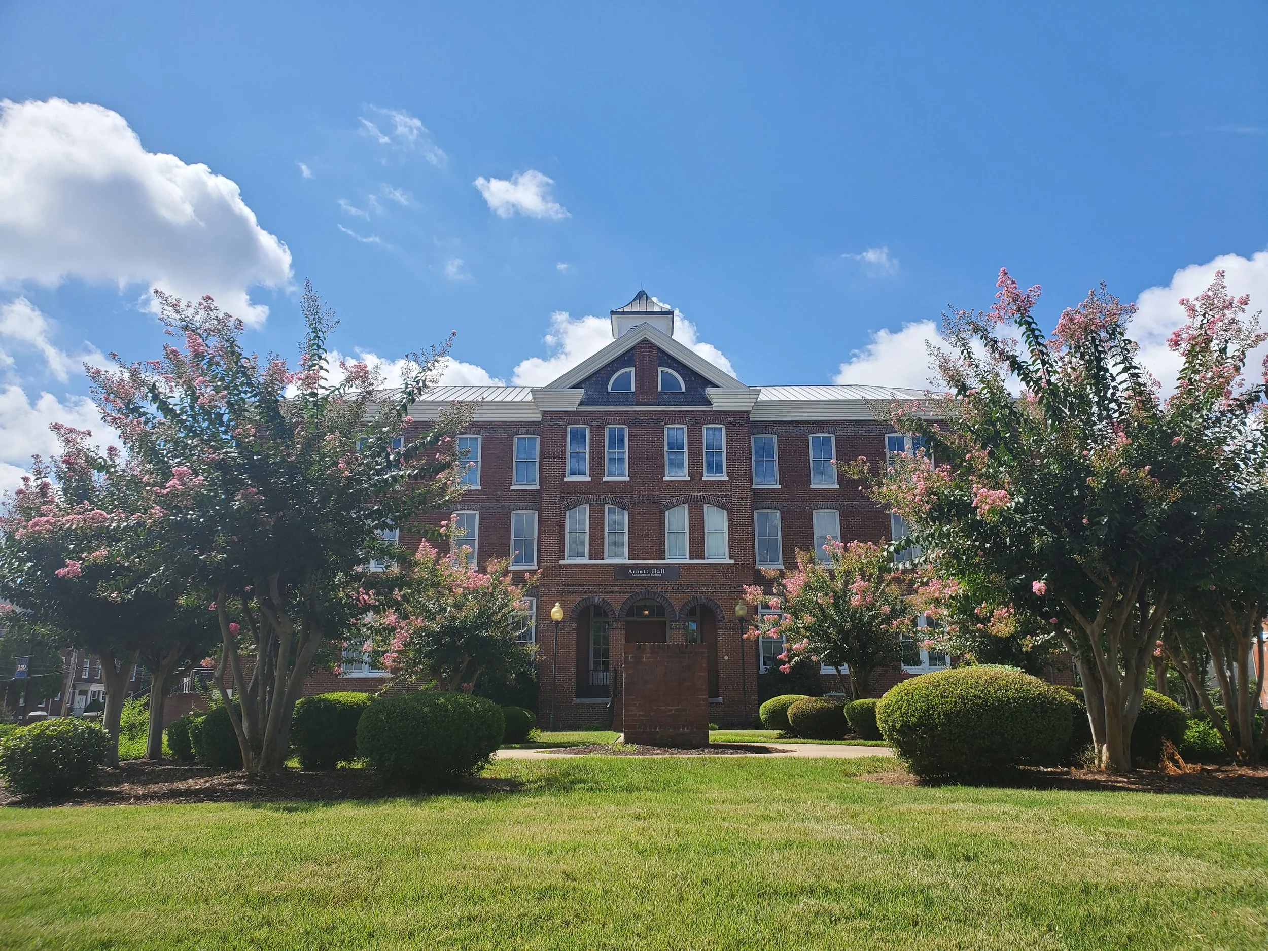 A historic building on Allen University’s campus under a blue sky