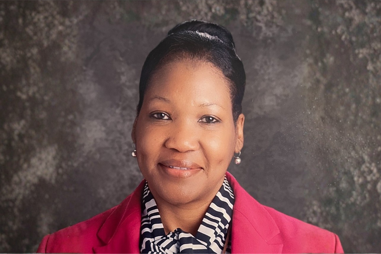 Dr. Toyletta Riley, Chair of the Levett School of Education at Allen University, smiling in a red blazer.