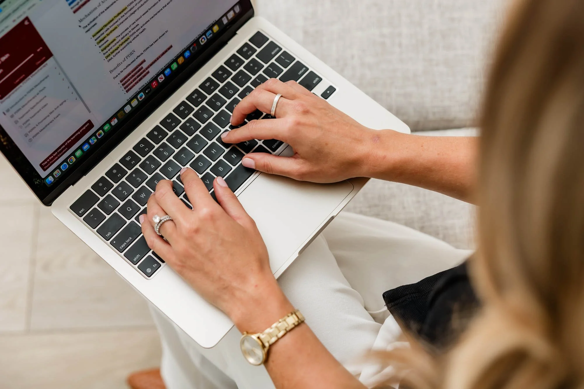 Close-up lifestyle photograph of a business owner working on her laptop