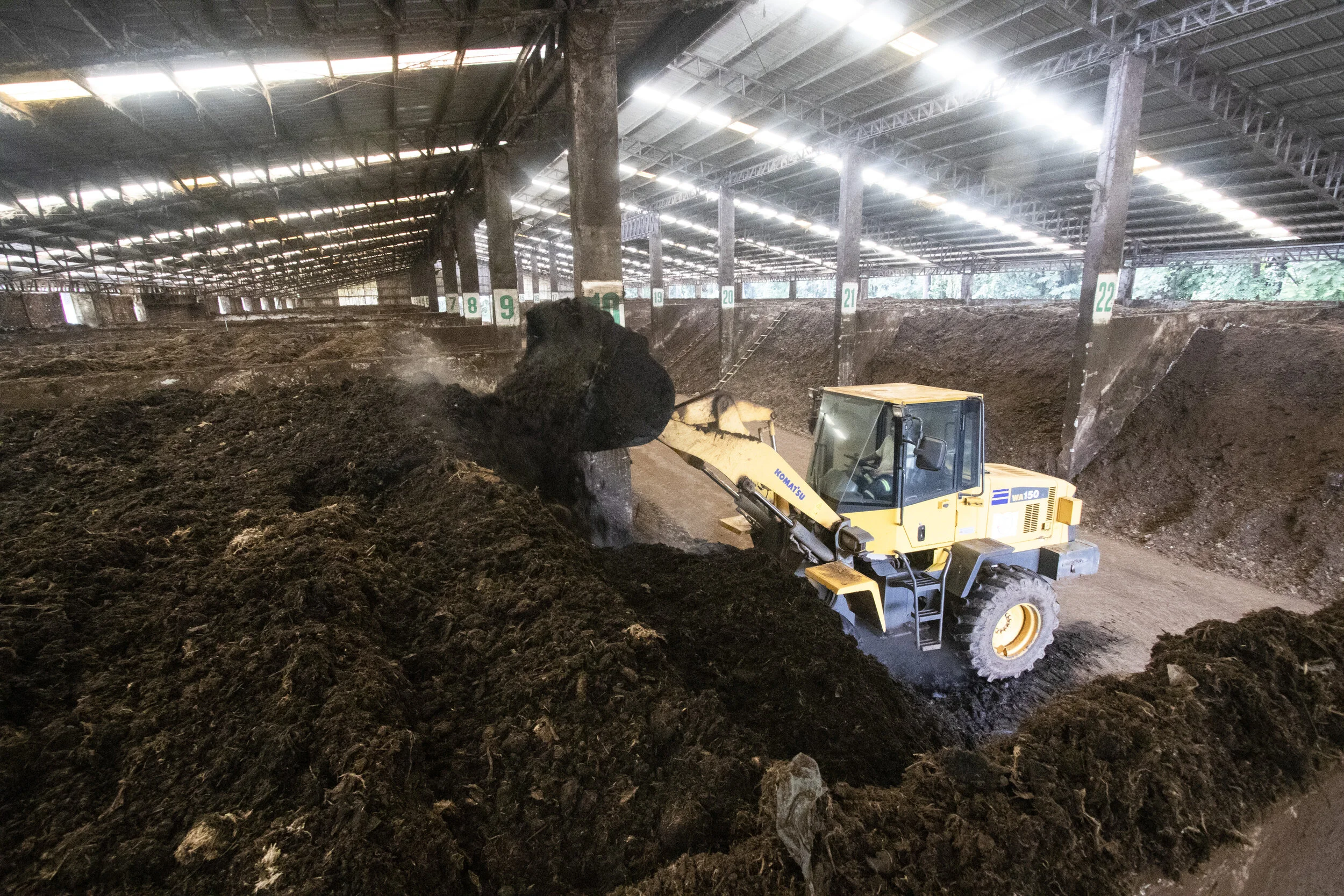 A pay loader turning the compost in one of the compartments
